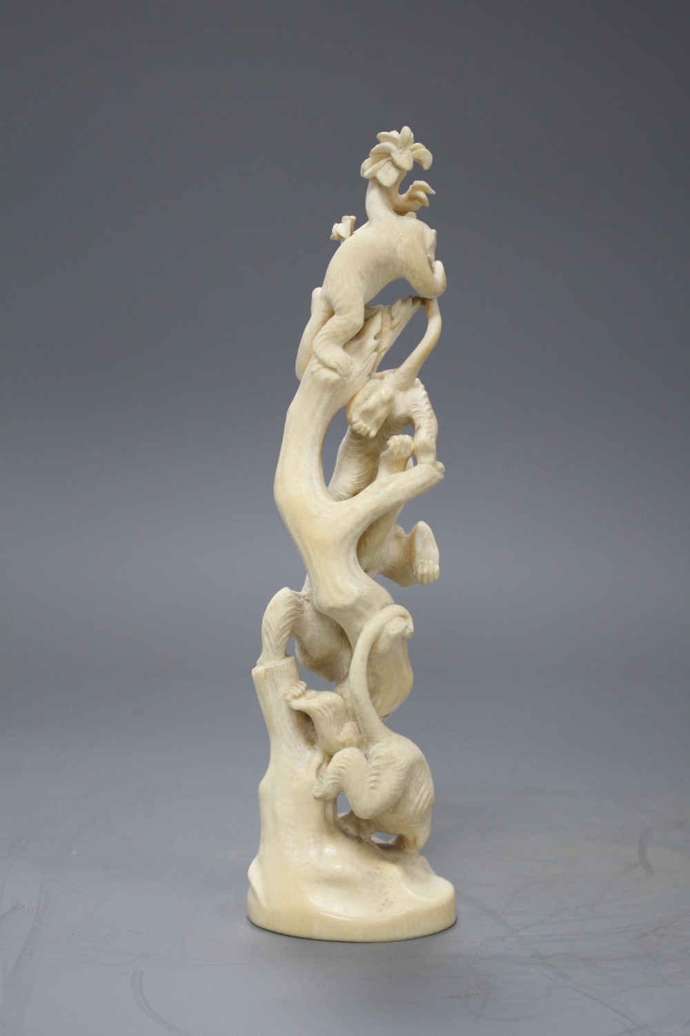 A Japanese Meiji period Tokyo School okimono carved with monkeys climbing a tree, unsigned, height 21.5cm